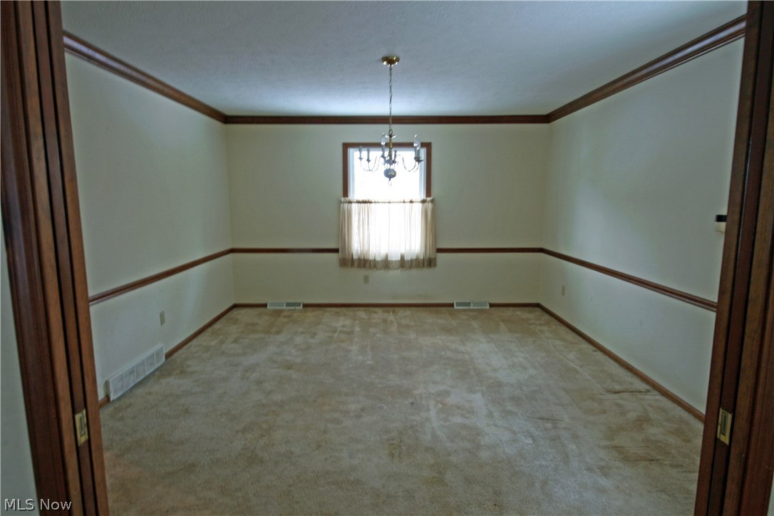 40564 Butternut Ridge Road Elyria, OH 44035 - Photo 4 of 9 Dining room with crown molding and chair rail. Pocket doors between dining and living rooms