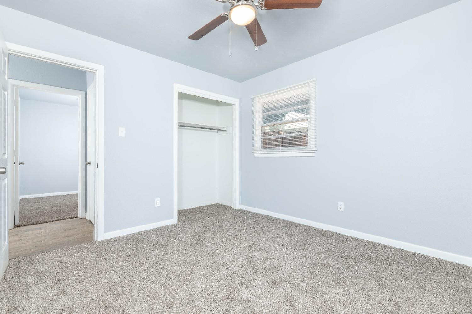 5116 47th Street Lubbock, TX 79414 - Photo 18 of 20 an empty room with closet and a chandelier fan