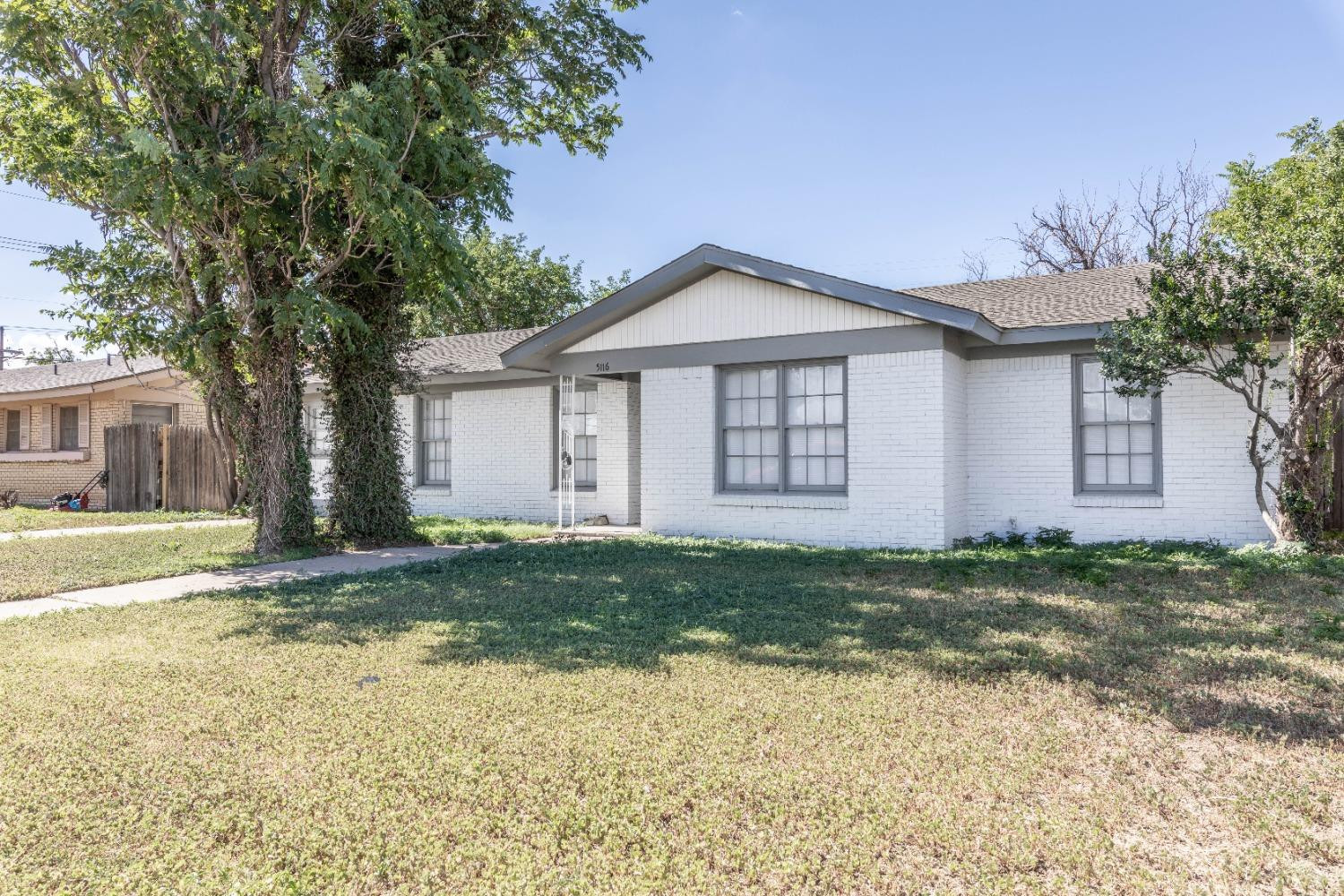 5116 47th Street Lubbock, TX 79414 - Photo 20 of 20 a front view of a house with a garden and yard