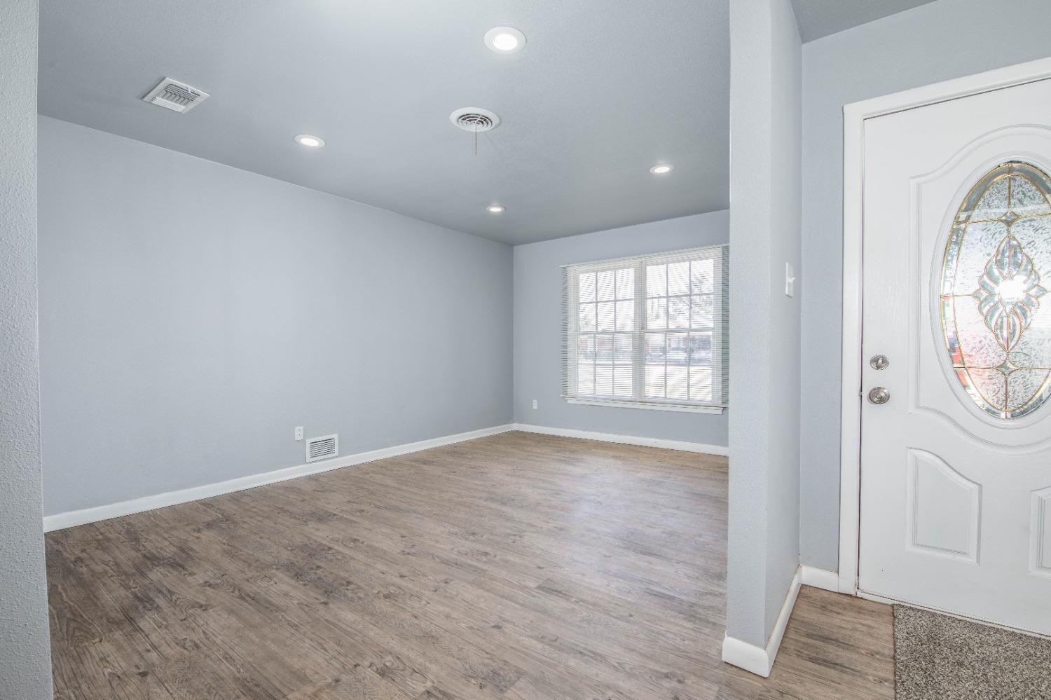 5116 47th Street Lubbock, TX 79414 - Photo 6 of 20 a view of empty room with wooden floor and fan
