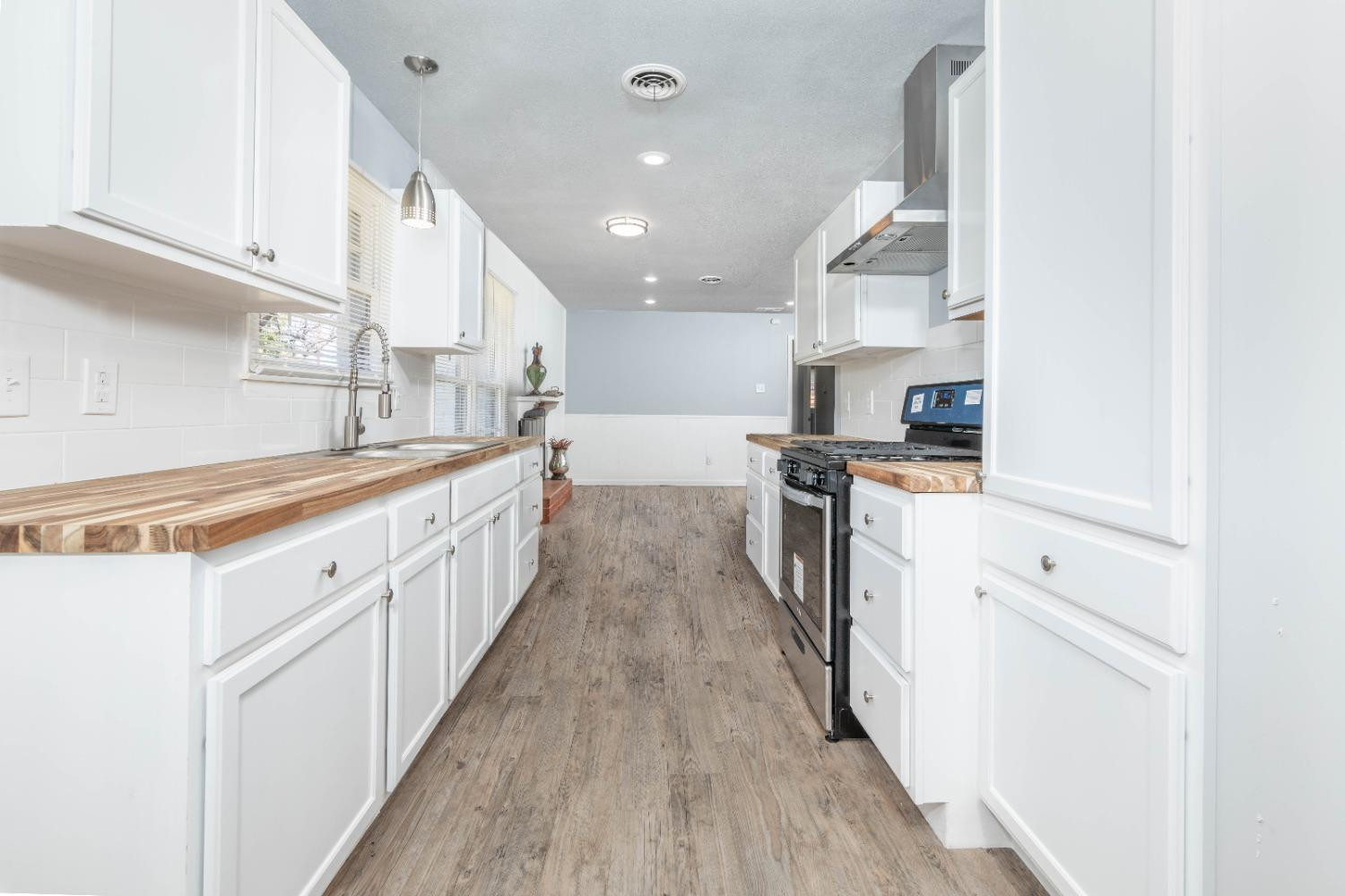 5116 47th Street Lubbock, TX 79414 - Photo 9 of 20 a kitchen with stainless steel appliances kitchen island granite countertop a sink and cabinets