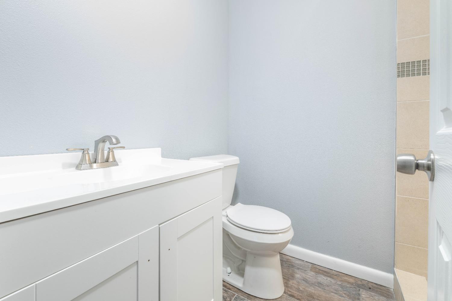 5116 47th Street Lubbock, TX 79414 - Photo 10 of 20 a bathroom with a sink a toilet and a mirror