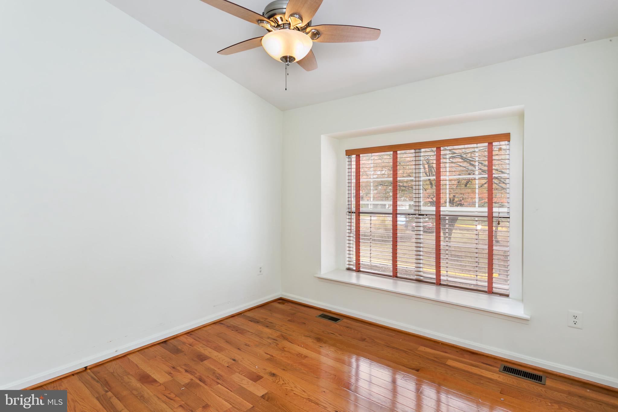 14 Tivoli Lake Court Silver Spring, MD 20906 - Photo 11 of 20 an empty room with a window and ceiling fan