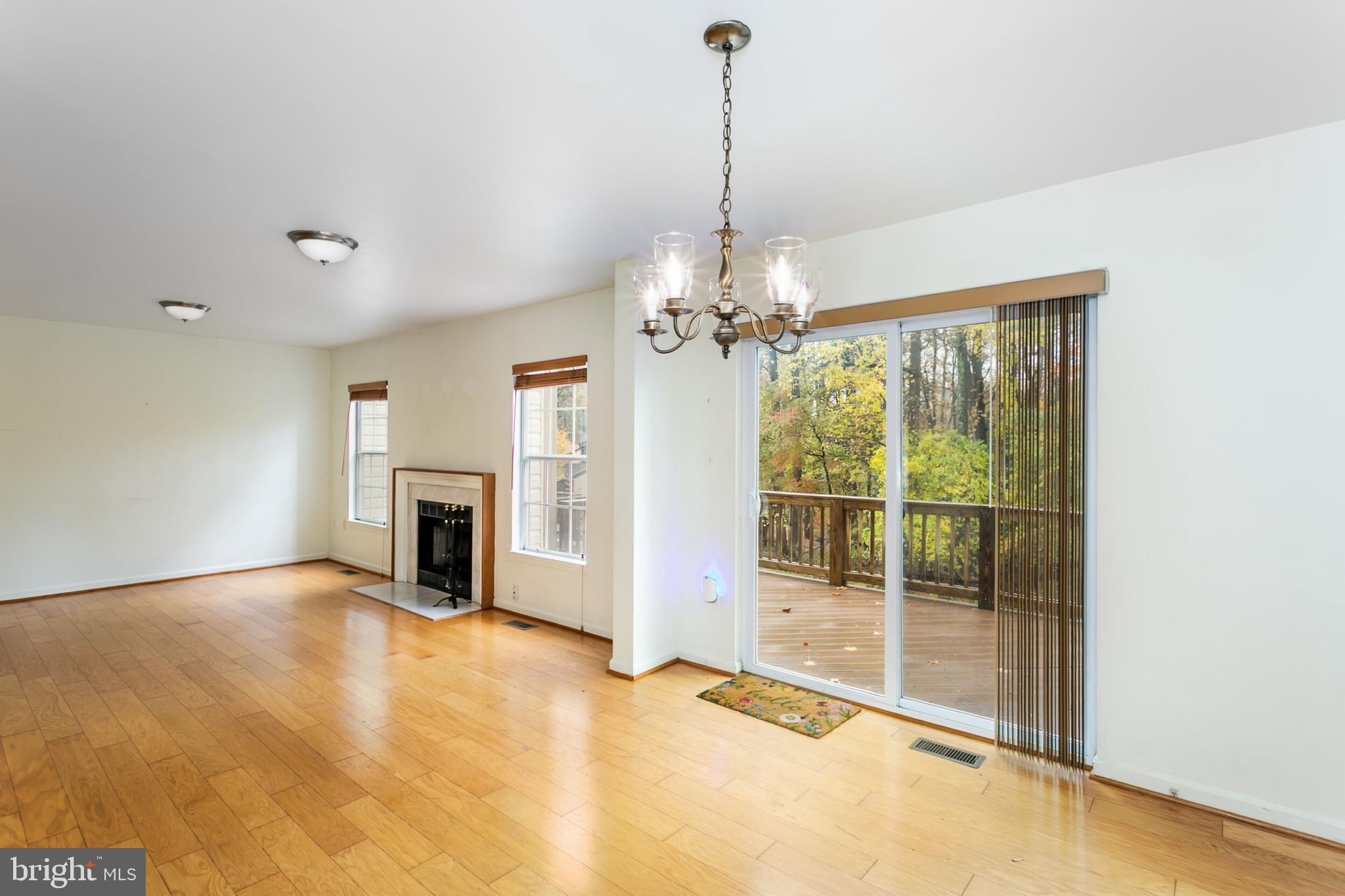 14 Tivoli Lake Court Silver Spring, MD 20906 - Photo 6 of 20 a view of a livingroom with a chandelier a fireplace and a chandelier