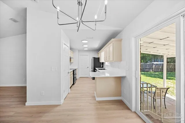 a view of kitchen with furniture and refrigerator
