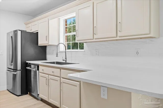 a kitchen with appliances cabinets and a sink