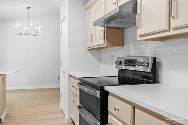 a kitchen with stainless steel appliances a stove and a refrigerator