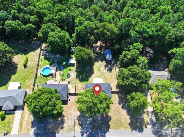 an aerial view of house with yard