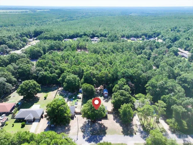 an aerial view of a house with lots of trees