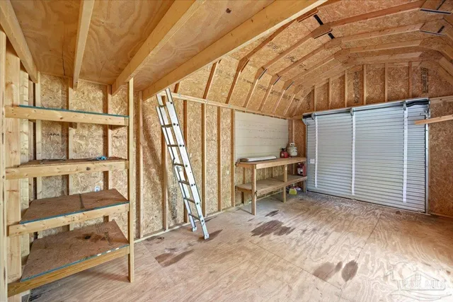 a view of a room with furniture and a window