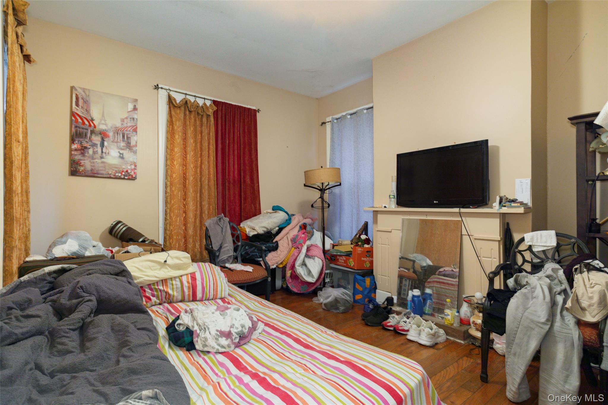 94 Academy Street Poughkeepsie, NY 12601 - Photo 15 of 19 a bed room with furniture and a flat screen tv