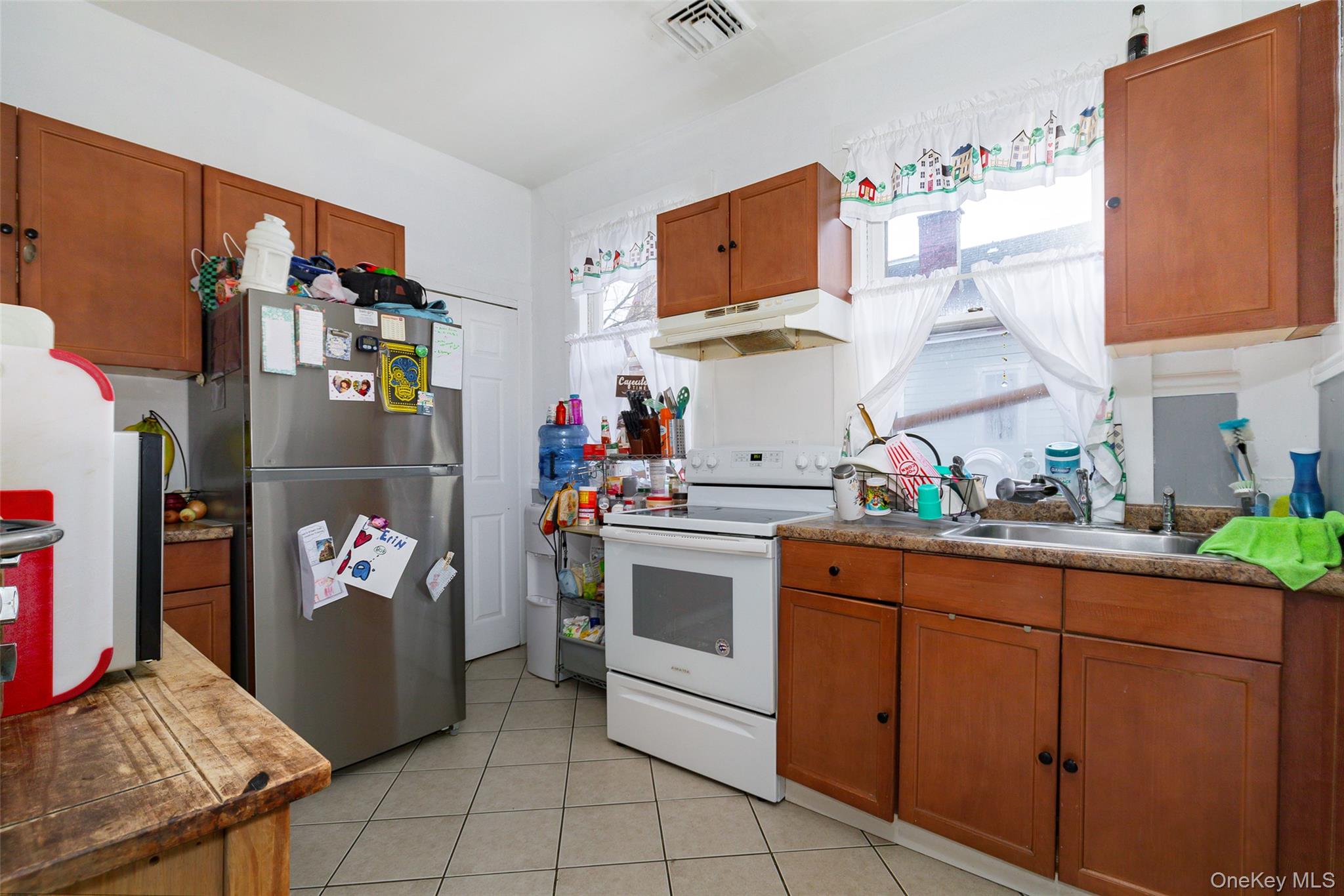 94 Academy Street Poughkeepsie, NY 12601 - Photo 3 of 19 a kitchen with stainless steel appliances granite countertop a refrigerator and a stove top oven