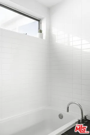 a bath tub sitting next to a shower