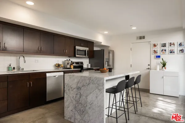a kitchen with a sink cabinets and window