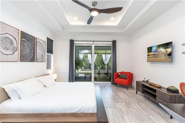 a bedroom with a bed a couch and a window