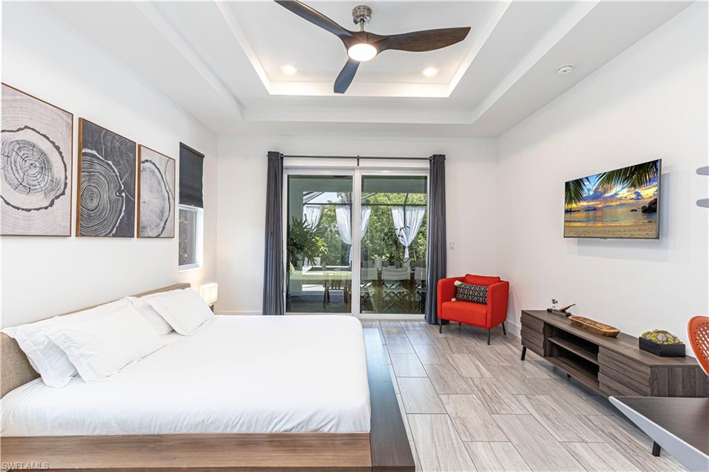 27180 Williams Road Bonita Springs, FL 34135 - Photo 13 of 42 a bedroom with a bed a couch and a window