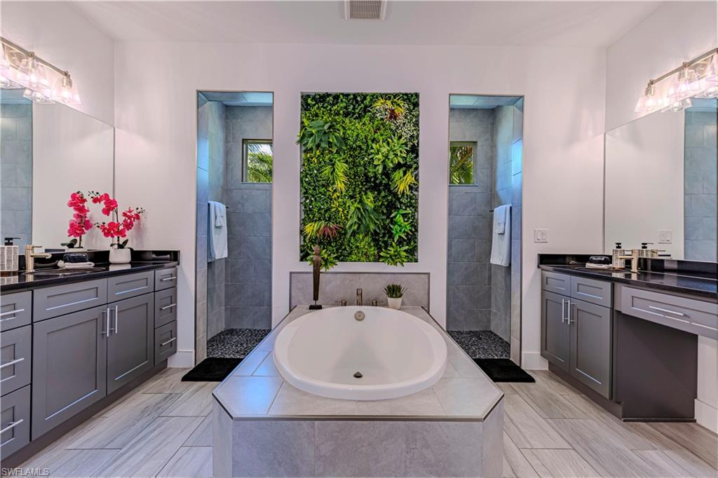 27180 Williams Road Bonita Springs, FL 34135 - Photo 15 of 42 a bathroom with a tub sink and mirror