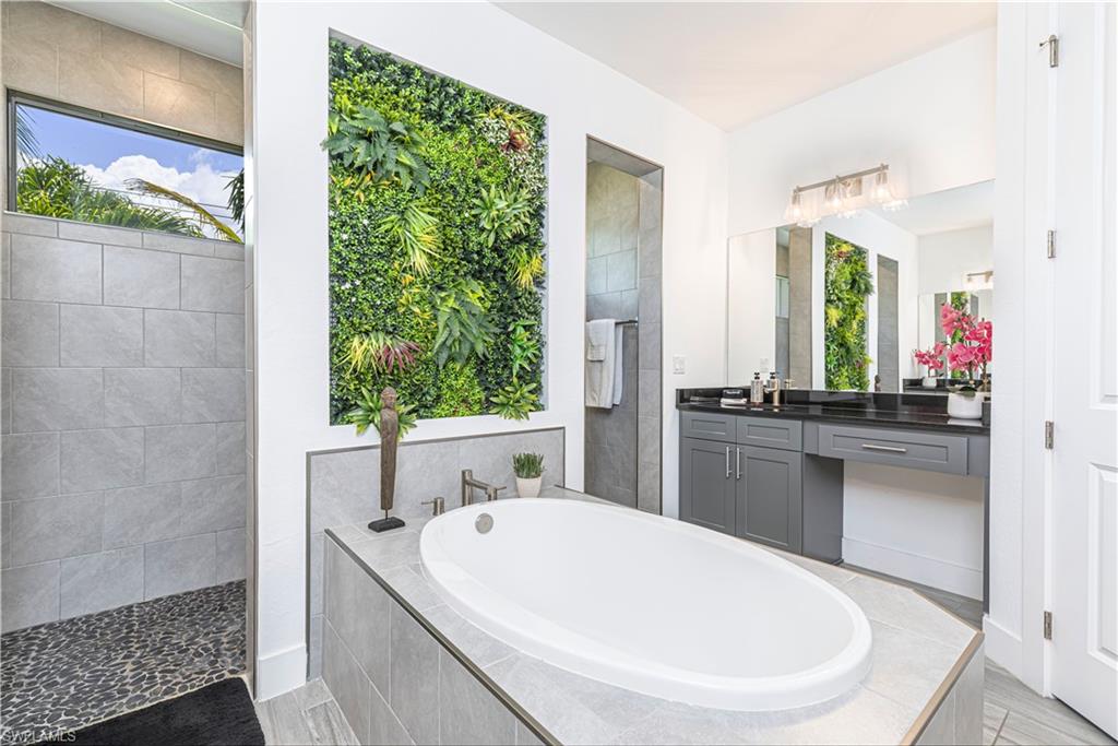 27180 Williams Road Bonita Springs, FL 34135 - Photo 17 of 42 a bathroom with a tub a sink and mirror