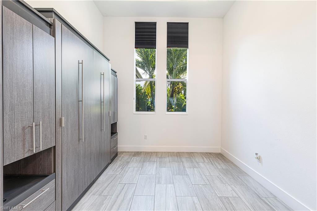 27180 Williams Road Bonita Springs, FL 34135 - Photo 21 of 42 an empty room with wooden floor and windows