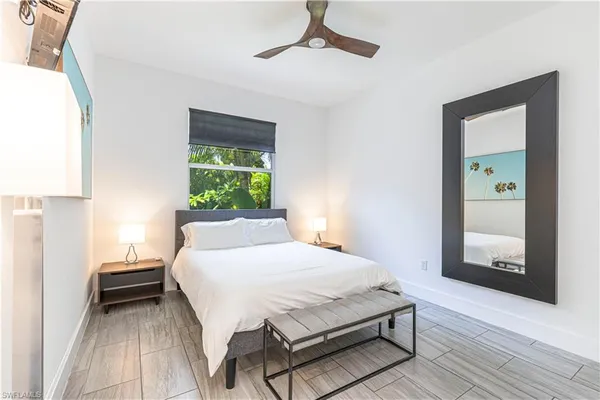 a bedroom with a bed table and a window