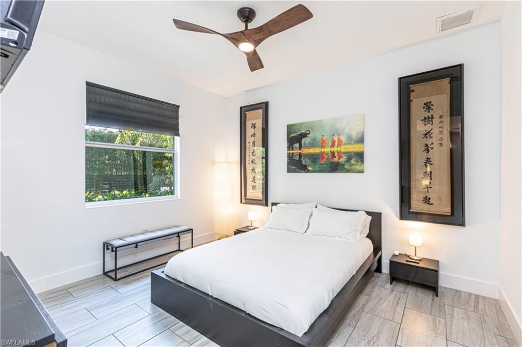 27180 Williams Road Bonita Springs, FL 34135 - Photo 25 of 42 a bedroom with a large bed and a window