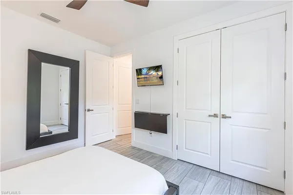 a bedroom with a bed and a cabinet