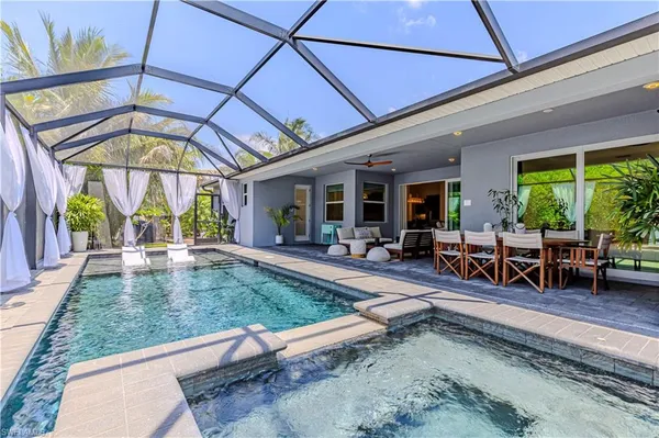 a view of a backyard with a patio and outdoor seating