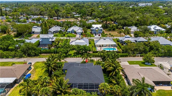 an aerial view of residential houses with outdoor space and swimming pool