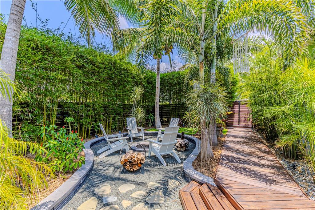 27180 Williams Road Bonita Springs, FL 34135 - Photo 5 of 42 a view of a backyard with chair and potted plants
