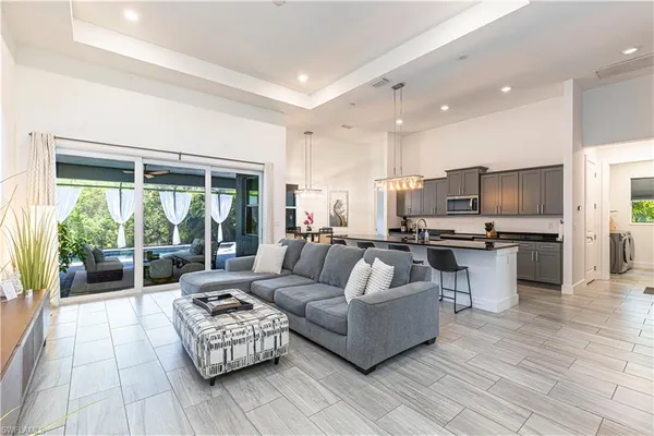 a living room with furniture and view of kitchen