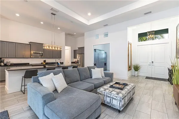 a living room with furniture and a view of kitchen