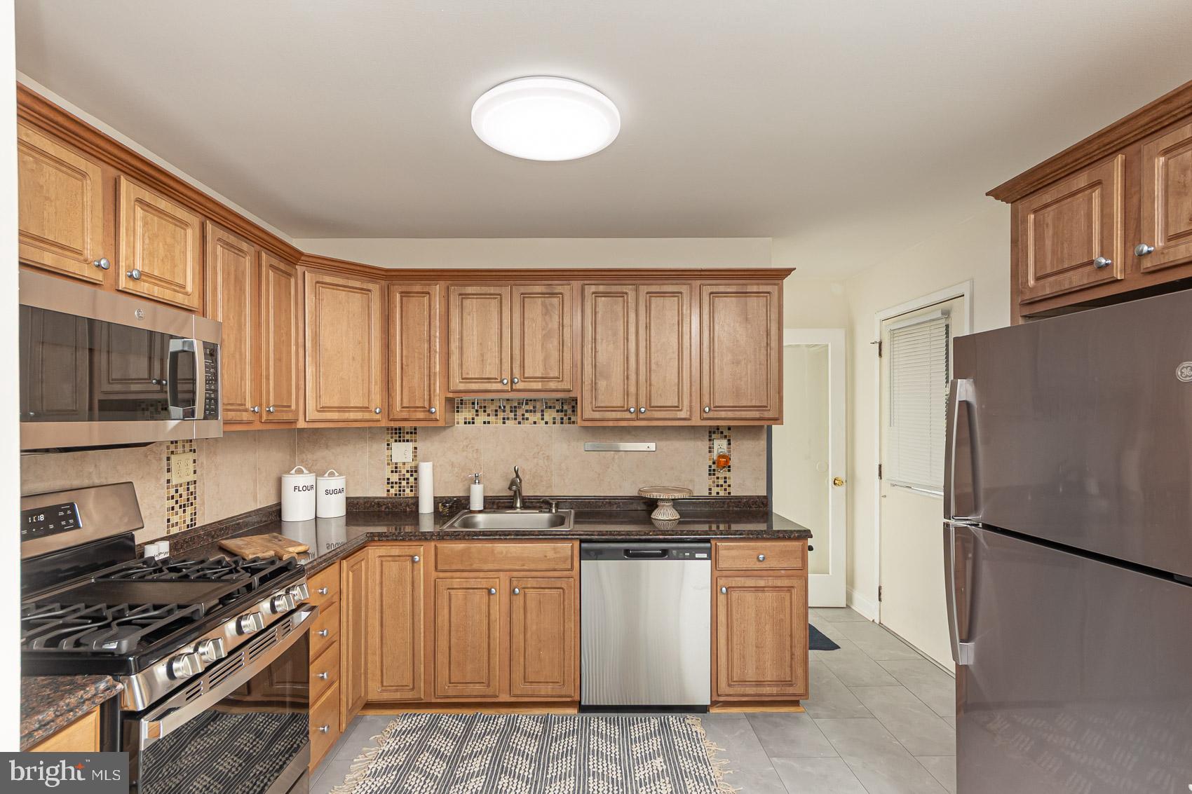 2011 Hanson Road Edgewood, MD 21040 - Photo 3 of 37 a kitchen with a refrigerator a stove a sink and cabinets
