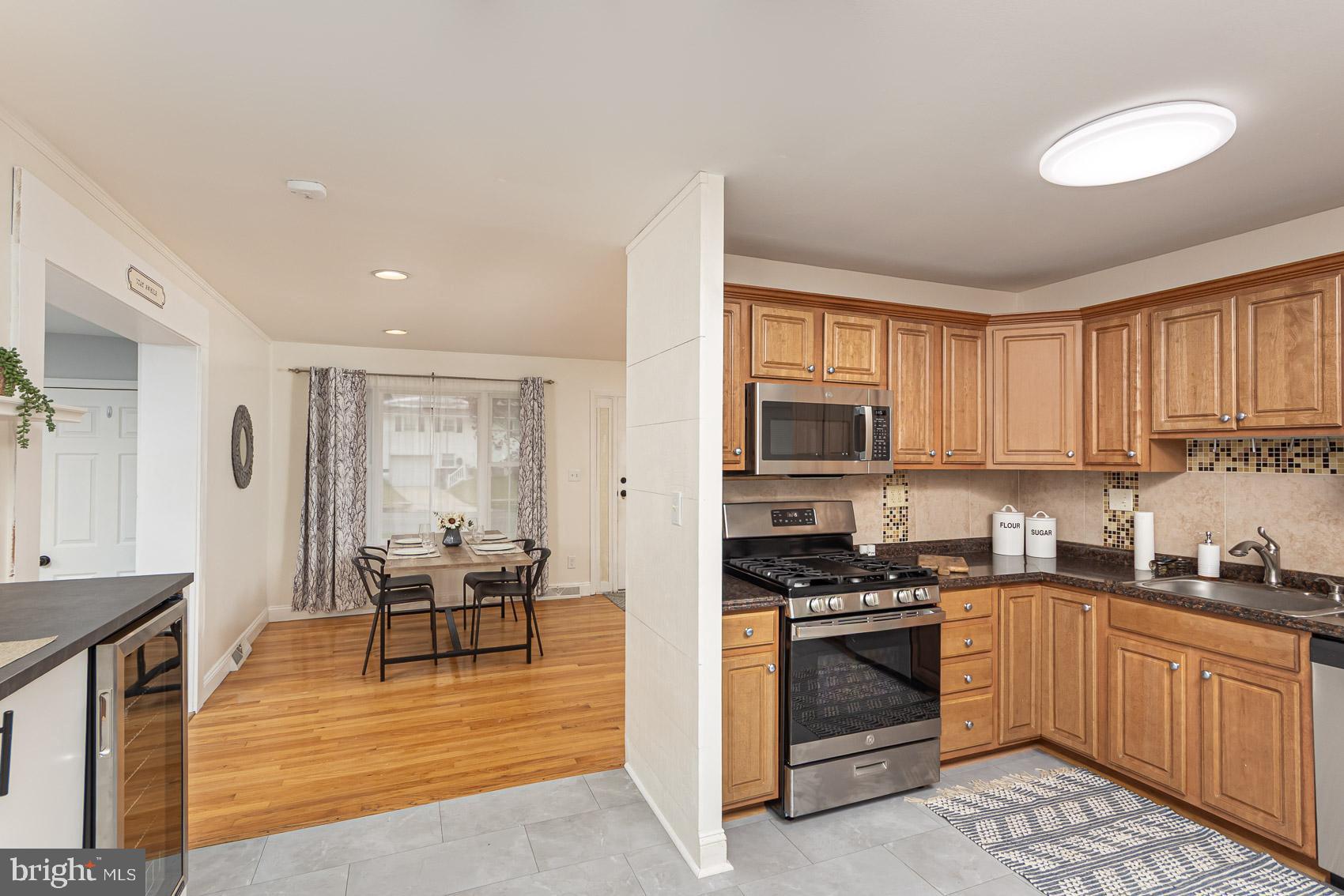 2011 Hanson Road Edgewood, MD 21040 - Photo 4 of 37 a kitchen with stainless steel appliances granite countertop a stove a sink dishwasher and a microwave oven with white cabinets