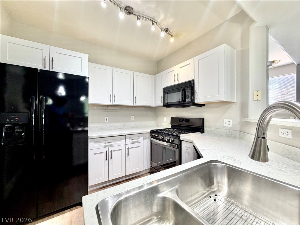 8555 West Russell Road, Unit 2018 Las Vegas, NV 89113 - Photo 4 of 23 A well-appointed kitchen features white cabinetry and sleek appliances for effortless meal preparation.