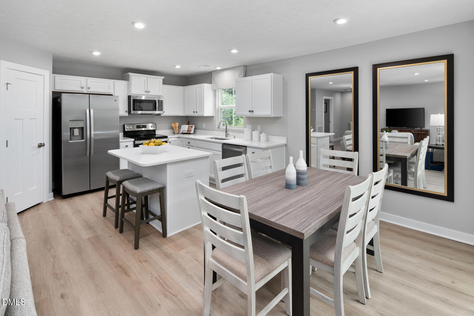 125 Springwood Lane Franklinton, NC 27525 - Photo 6 of 26 a kitchen with stainless steel appliances granite countertop a dining table chairs refrigerator and microwave