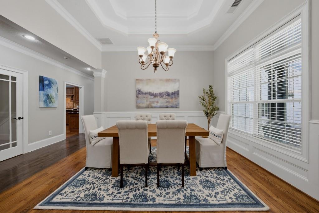 582 Knox Chapel Road Social Circle, GA 30025 - Photo 6 of 49 a dining room with wooden floor a chandelier a wooden table and chairs