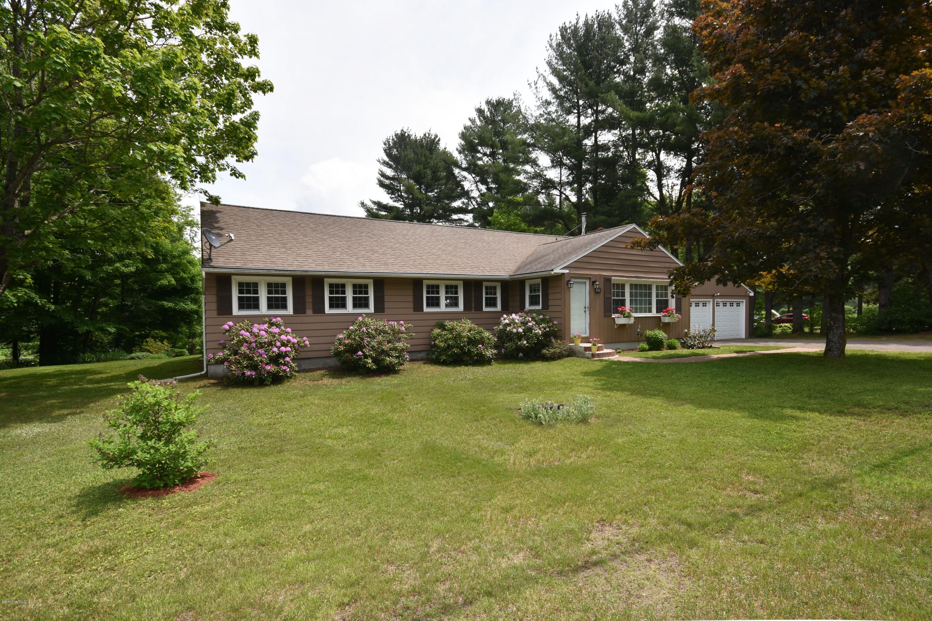 489 South Washington State Road Washington, MA 01223 - Photo 1 of 49 a front view of a house with a yard table and chairs
