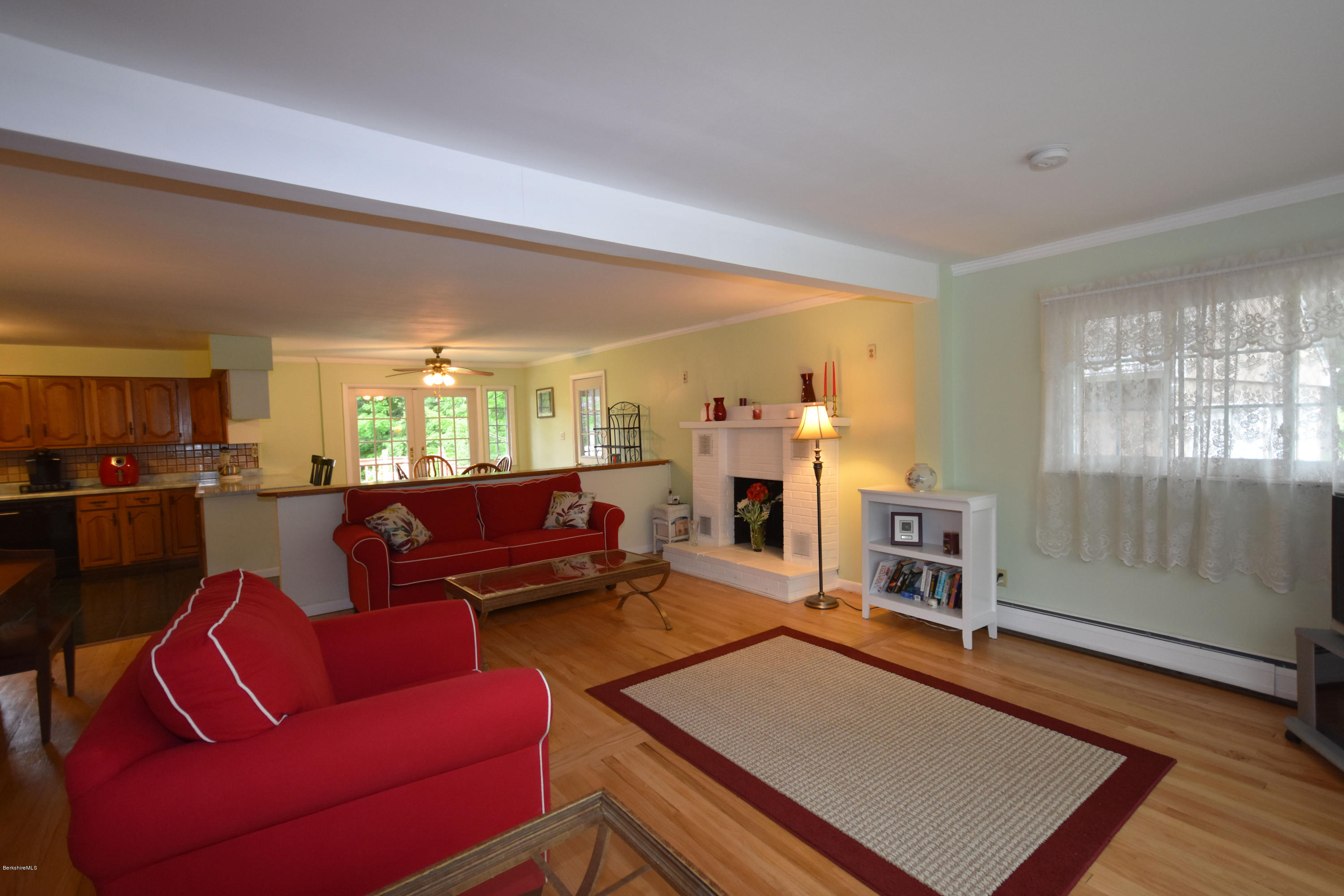 489 South Washington State Road Washington, MA 01223 - Photo 9 of 49 a living room with furniture a fireplace and a view of kitchen