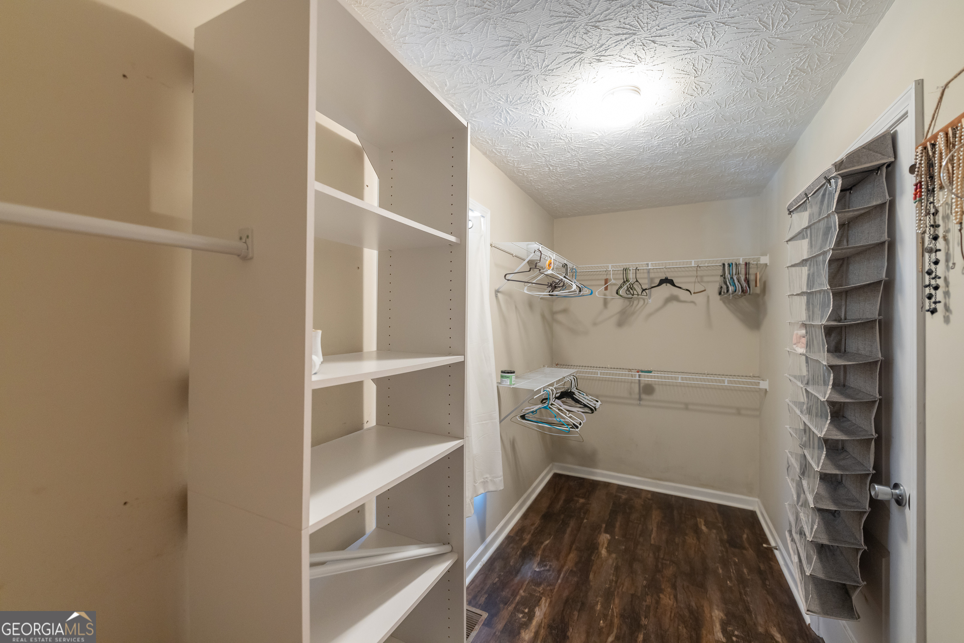 123 Rabbit Run Drive Meansville, GA 30256 - Photo 23 of 101 a view of walk in closet with empty racks