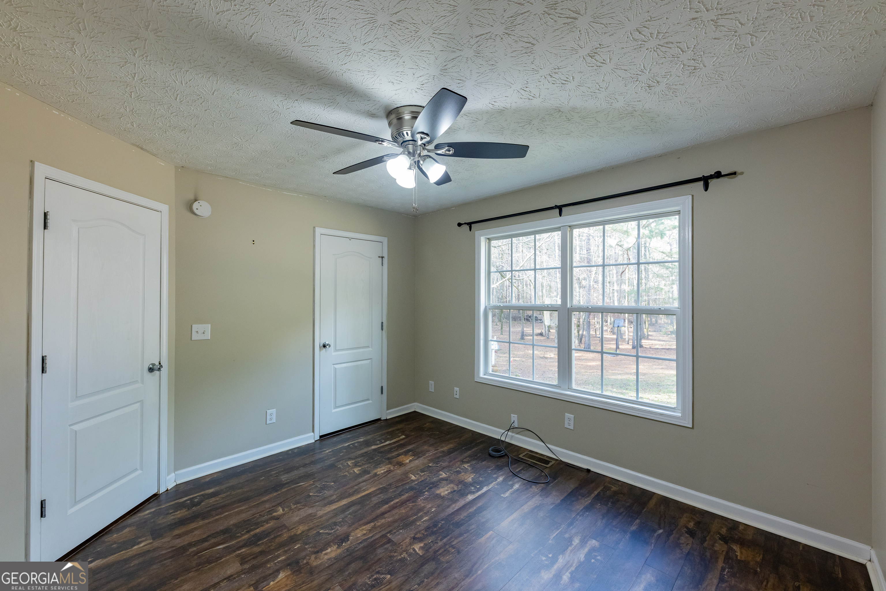 123 Rabbit Run Drive Meansville, GA 30256 - Photo 25 of 101 a view of empty room with wooden floor and fan