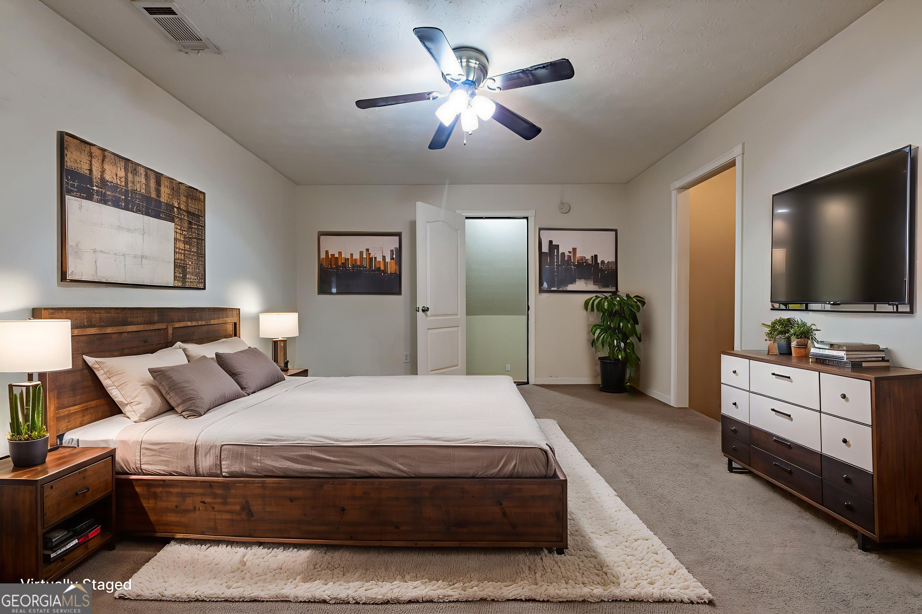 123 Rabbit Run Drive Meansville, GA 30256 - Photo 36 of 101 a spacious bedroom with a bed and a flat screen tv