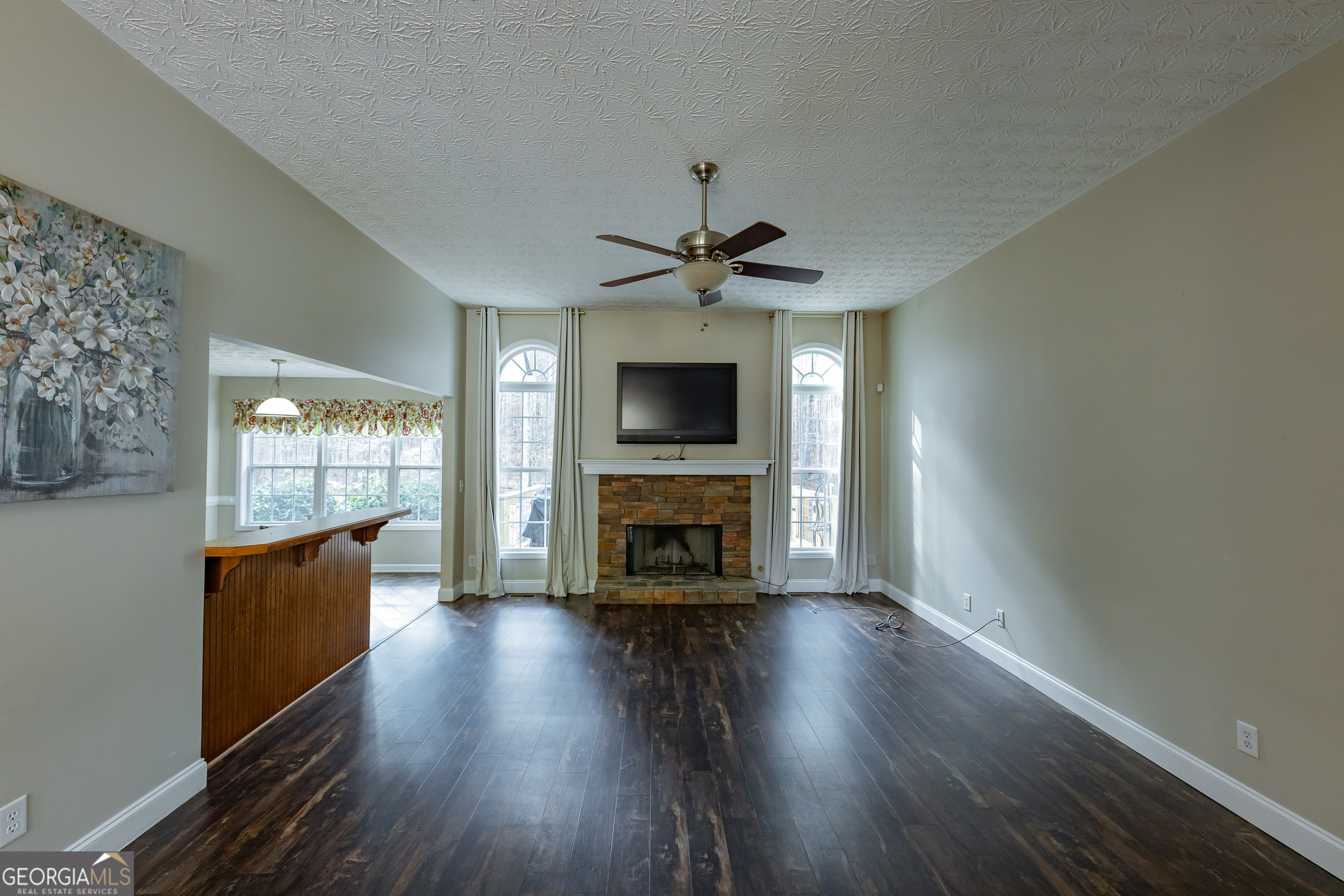 123 Rabbit Run Drive Meansville, GA 30256 - Photo 6 of 101 wooden floor in an empty room with a fireplace