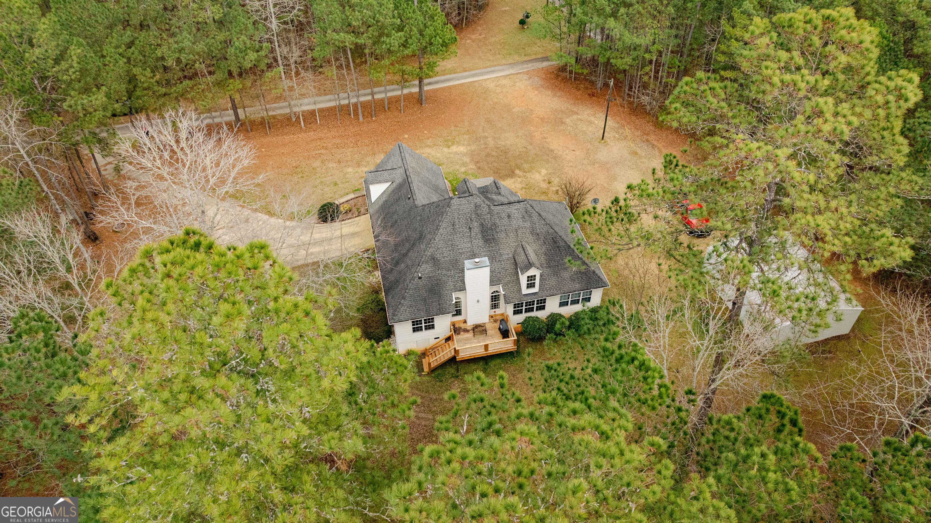 123 Rabbit Run Drive Meansville, GA 30256 - Photo 64 of 101 a backyard of a house with table and chairs