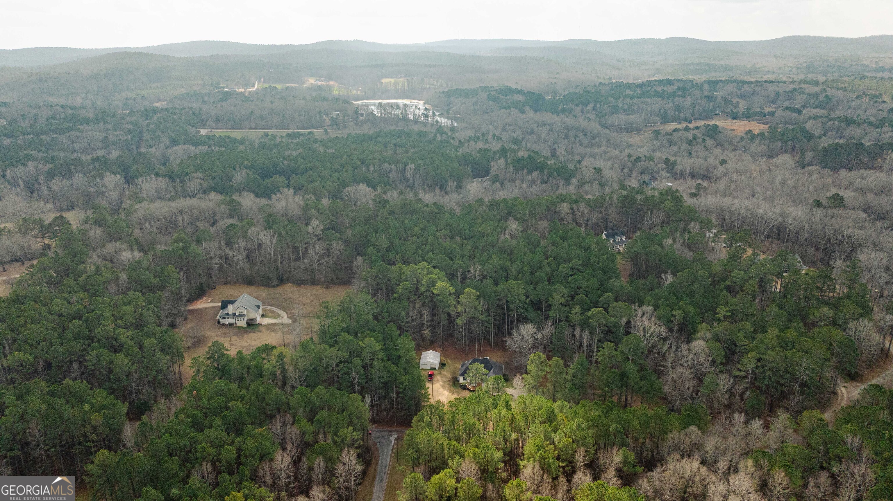 123 Rabbit Run Drive Meansville, GA 30256 - Photo 100 of 101 an aerial view of a city with lots of residential buildings and mountain view in back