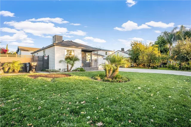 a house view with swimming pool and garden space
