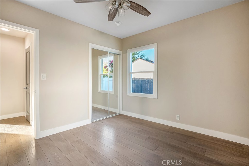 8466 Quartz Avenue Winnetka, CA 91306 - Photo 11 of 16 an empty room with wooden floor fan and windows