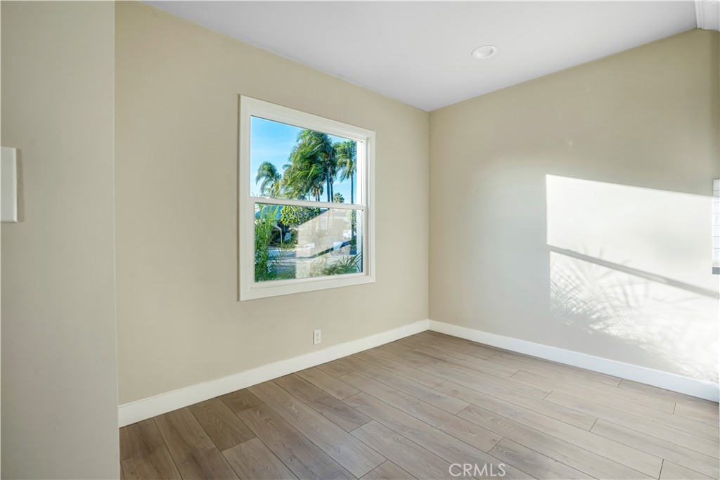 8466 Quartz Avenue Winnetka, CA 91306 - Photo 5 of 16 an empty room with wooden floor and windows