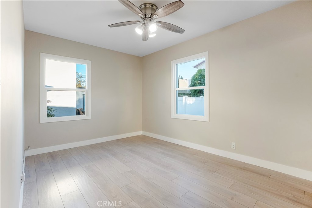 8466 Quartz Avenue Winnetka, CA 91306 - Photo 8 of 16 wooden floor in an empty room with a window