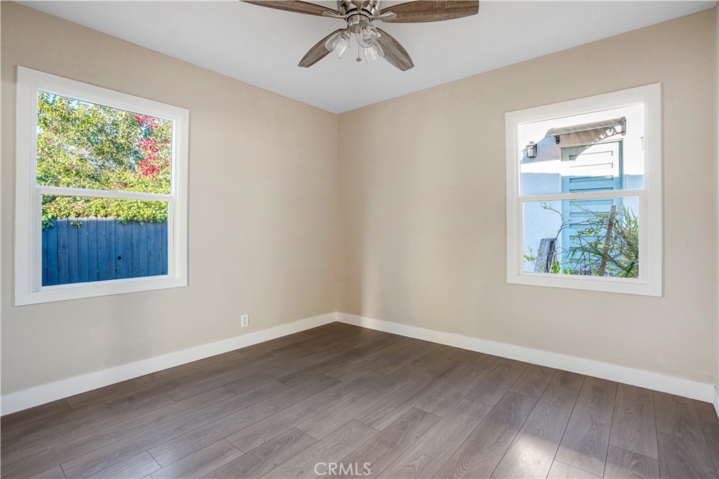 8466 Quartz Avenue Winnetka, CA 91306 - Photo 9 of 16 a view of an empty room with wooden floor and a window