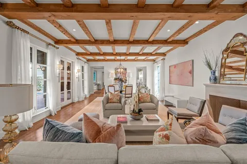 a living room with furniture and a chandelier